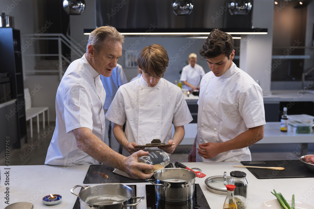 Group of chefs working at restaurant kitchen Group of chefs working at restaurant kitchen