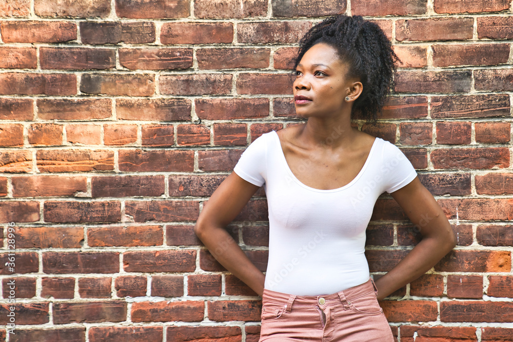 Colombian fashion woman outside close to a brick wall Colombian fashion woman outside close to a brick wall