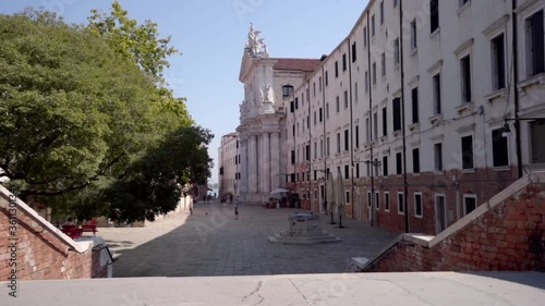 Wallpaper Mural Venice Italy. View of a old white church and a typical Italian square meanwhile people play football Torontodigital.ca