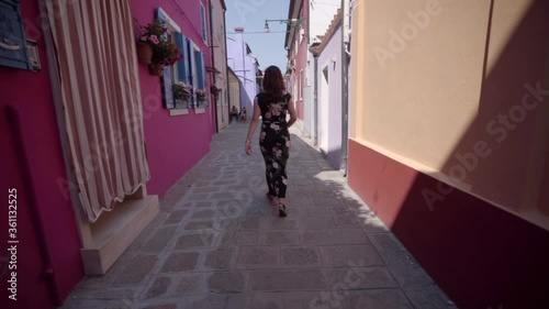 Wallpaper Mural Attractive young woman walking on the street of Venice Italy looking at the beautiful colorful buildings Torontodigital.ca