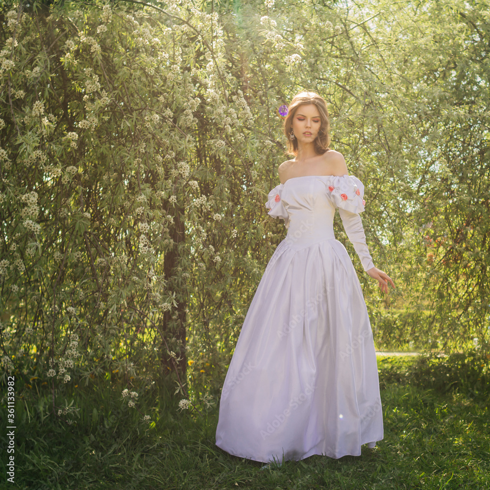 Princess walking in flowering garden