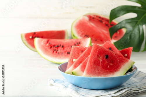 Composition with plate of fresh watermelon on white wooden background