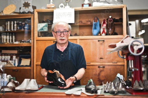 
portrait of senior shoemaker in his workshop