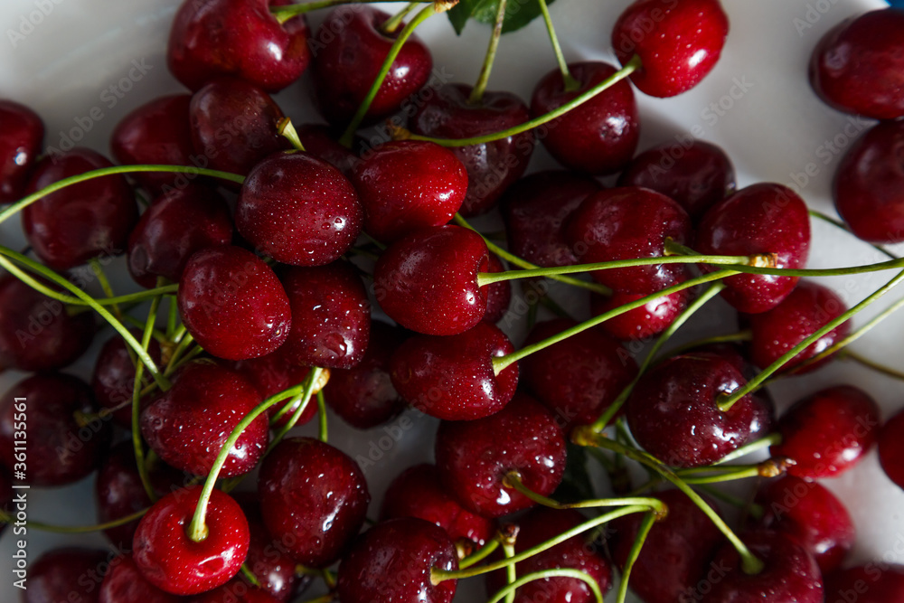 Fresh cherry on plate on wooden blue background. Fresh cherry on plate on wooden blue background.