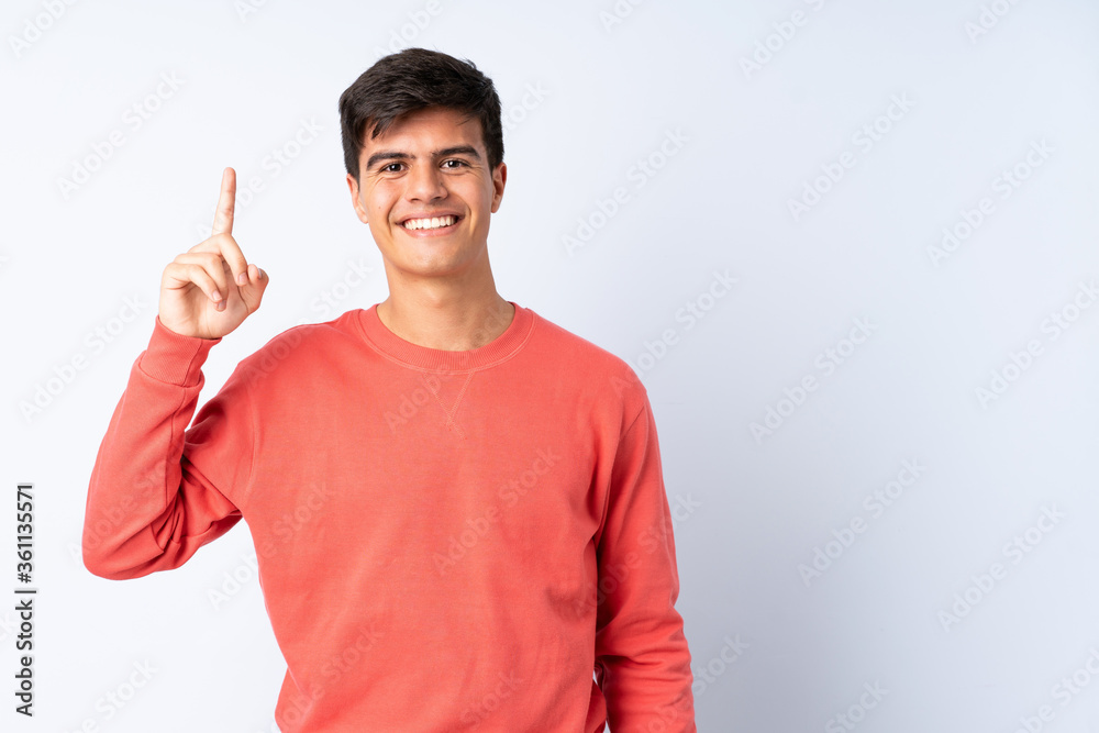Handsome man over isolated blue background pointing up a great idea Handsome man over isolated blue background pointing up a great idea