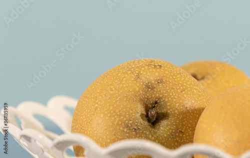 Asian pear (Pyrus pyrifolia A.) in white tray on blue background. photo