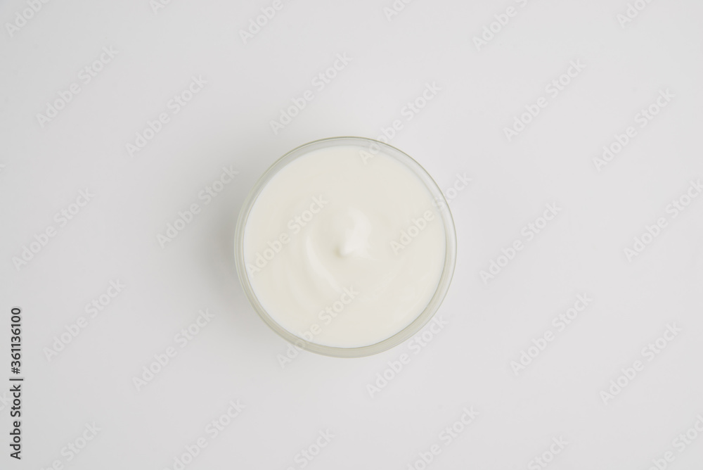 Sour cream. Sour cream in a saucepan. Saucepan with sour cream on a white plate Sour cream. Sour cream in a saucepan. Saucepan with sour cream on a white plate