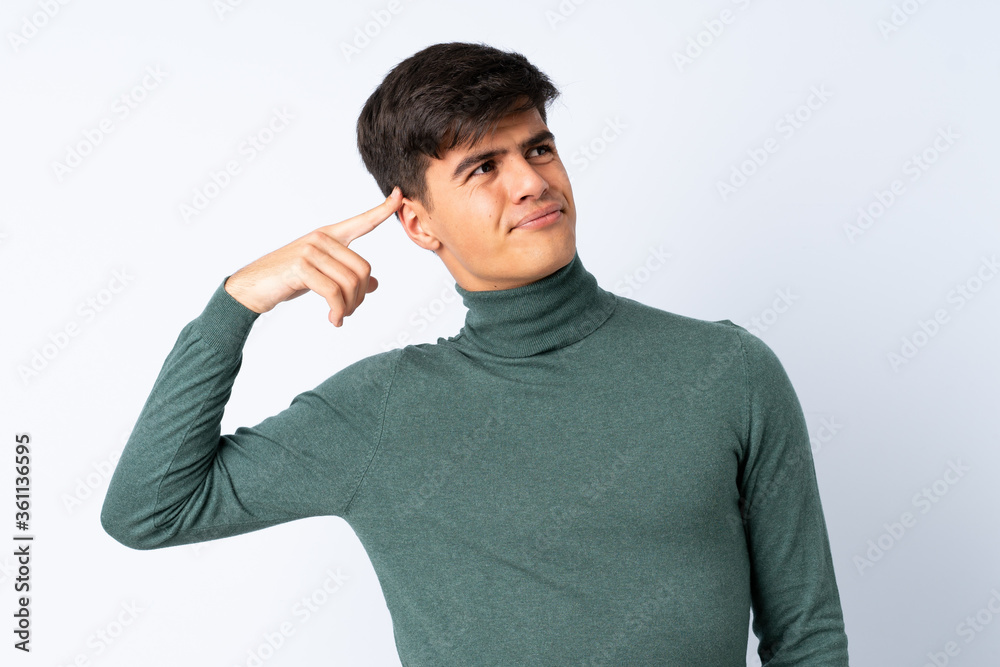 Handsome man over isolated blue background making the gesture of madness putting finger on the head Handsome man over isolated blue background making the gesture of madness putting finger on the head