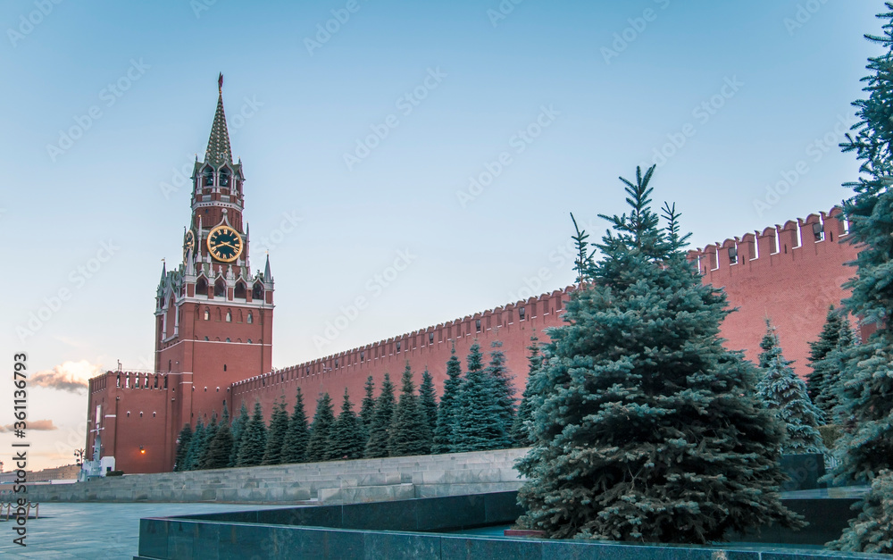 Spasskaya Tower and the walls of the Moscow Kremlin against the blue sky in Red Square. Russia Spasskaya Tower and the walls of the Moscow Kremlin against the blue sky in Red Square. Russia