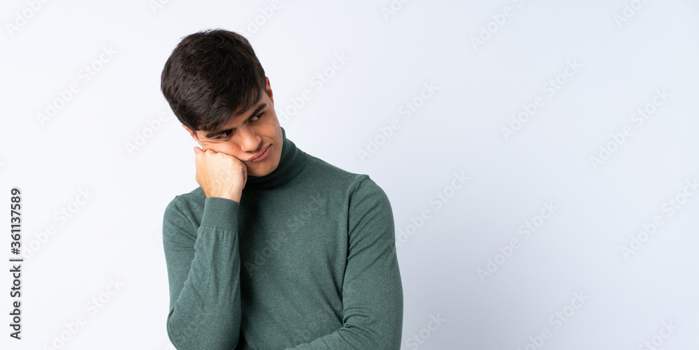 Handsome man over isolated blue background with tired and bored expression Handsome man over isolated blue background with tired and bored expression