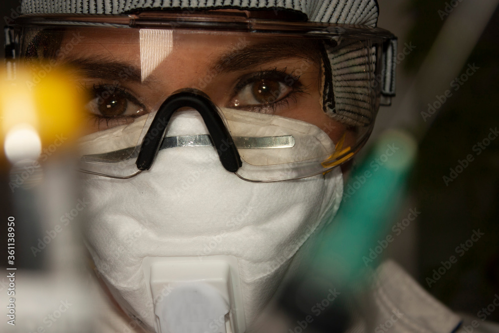 .Doctor specialized in managing covid-19 disease protected with glasses and covers mouths