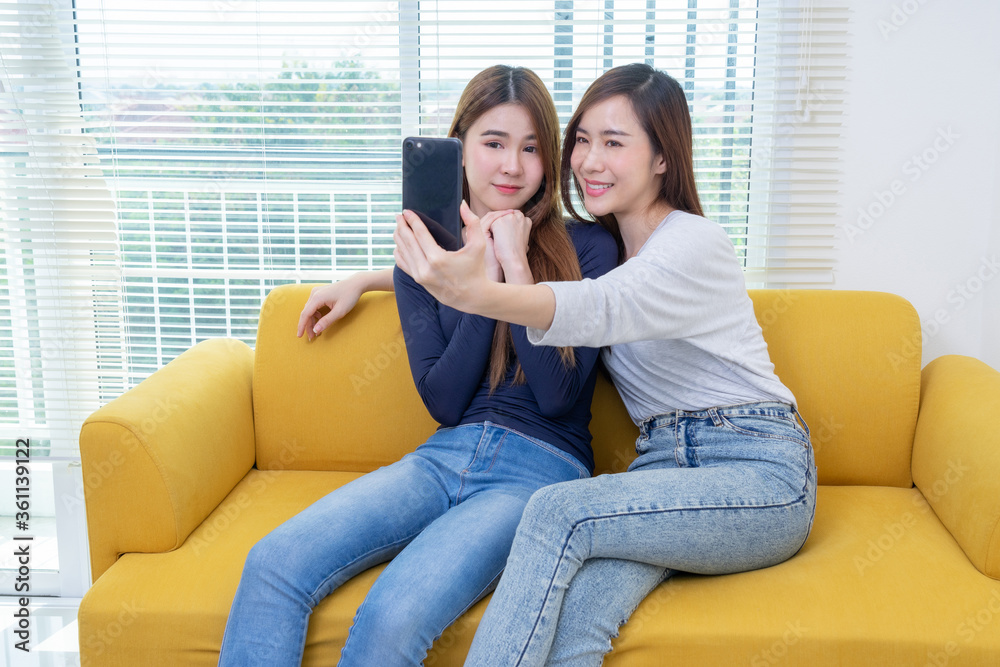 A couple of beautiful asian woman take photo while smiling, Same sex young married female couple in their daily routine showing some affection LGBT lesbian A couple of beautiful asian woman take photo while smiling, Same sex young married female couple in their daily routine showing some affection LGBT lesbian