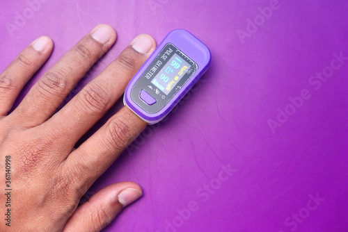  Man finger with pulse oximeter to measure oxygen saturation