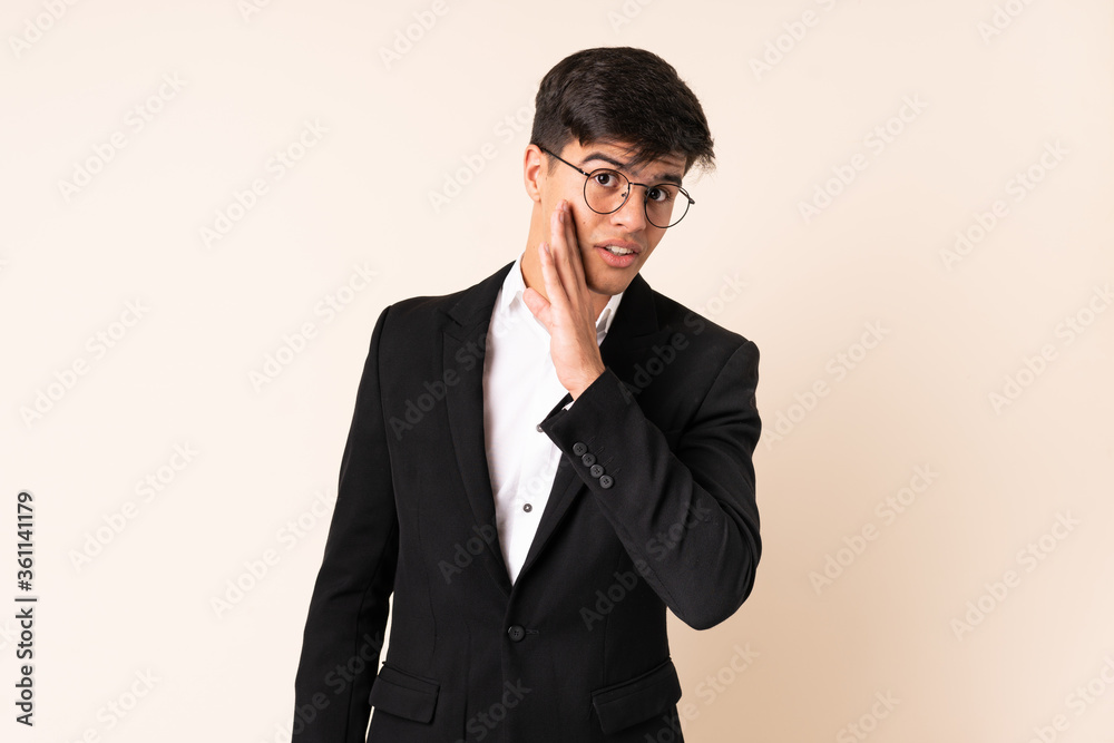 Businessman over isolated beige background whispering something Businessman over isolated beige background whispering something