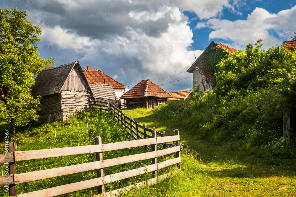 Small mountain village with old rustic houses at the springtime on Zlatibor mountain in Serbia Small mountain village with old rustic houses at the springtime on Zlatibor mountain in Serbia