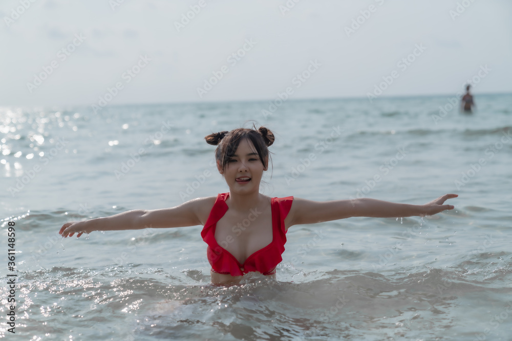 Young sexy woman in bikini enjoying summer vacation on beach relaxing holiday Young sexy woman in bikini enjoying summer vacation on beach relaxing holiday