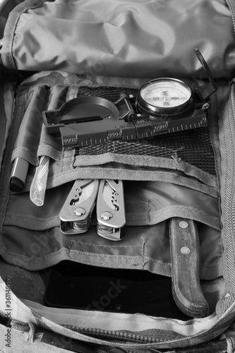 Compass, knife and multitool in a backpack