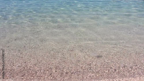 Beautiful background of crystal clear transparent sea water surf at pebble beach at sunny day in Sumartin, Brac island, Croatia