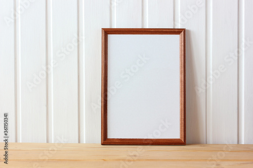 empty wooden frame on the table. mockup, scene creator.