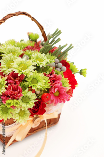 Bouquet of flowers in basket isolated on white background