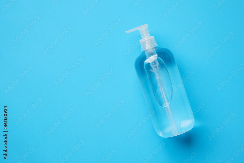 Alcohol hand sanitizer gel bottle on blue background protection against COVID-19 coronavirus. Healthcare and medical concept Alcohol hand sanitizer gel bottle on blue background protection against COVID-19 coronavirus. Healthcare and medical concept