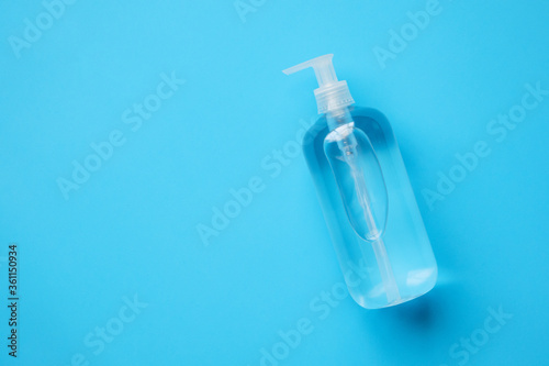 Alcohol hand sanitizer gel bottle on blue background protection against COVID-19 coronavirus. Healthcare and medical concept