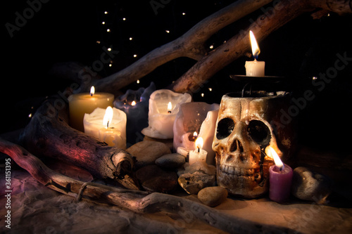 Skull and candles on a gloomy shelf