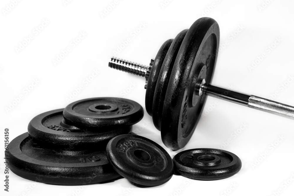 some different size workout weights and a heavy barbell isolated some different size workout weights and a heavy barbell isolated