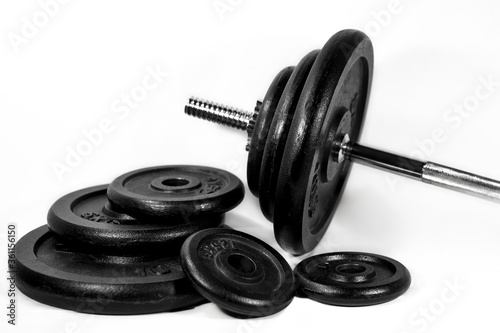 some different size workout weights and a heavy barbell isolated