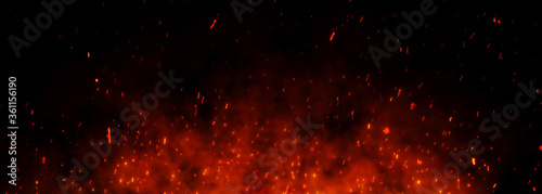 fire sparks over black background. Fire sparks background. Abstract dark glitter fire particle lights. 