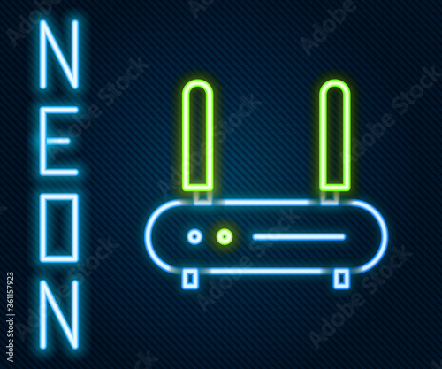 Glowing neon line Router and wi-fi signal icon isolated on black background. Wireless ethernet modem router. Computer technology internet. Colorful outline concept. Vector Illustration.
