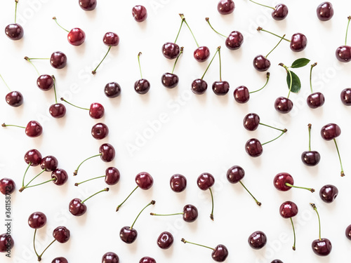 Frame of large ripe cherry berries on white background. Natural summer food background. Creative food summer layout. top view. Copy space