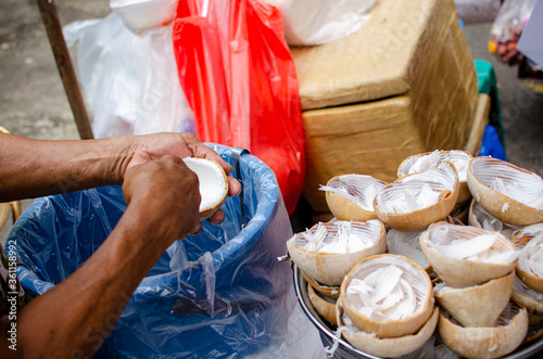 man grating coconut photo