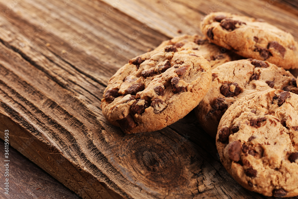 Chocolate cookies on wooden table. Chocolate chip cookies shot on vintage background Chocolate cookies on wooden table. Chocolate chip cookies shot on vintage background