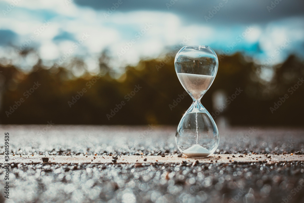 hourglass clock on the road with copy space. - obrazy, fototapety, plakaty 