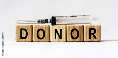 Text DONOR made from wooden cubes. White background