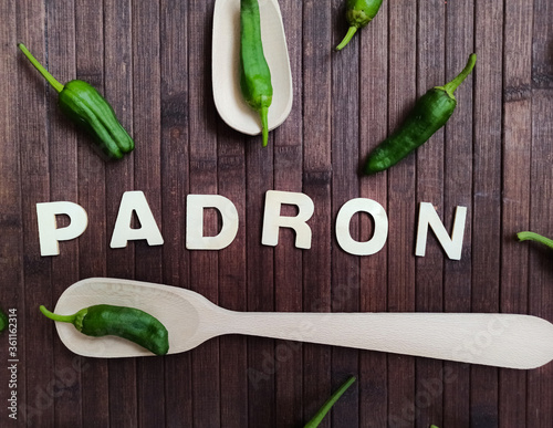 Padrón peppers background on a wooden table with the word that says Padrón in wooden letter