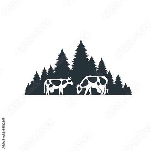 Cows on the background of the forest