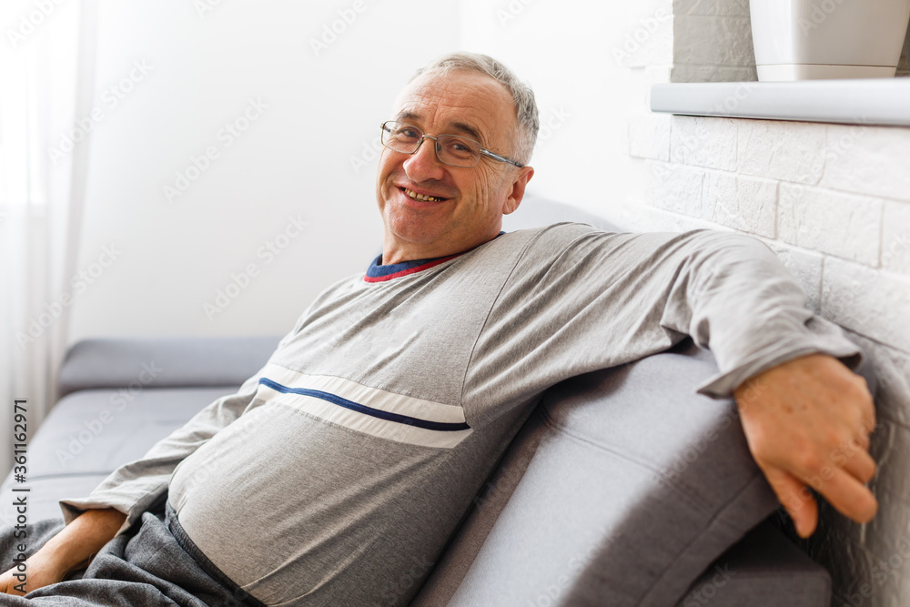 An elderly man sitting in a chair at his home, closeup with copy space An elderly man sitting in a chair at his home, closeup with copy space
