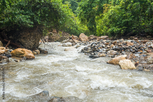 The mountain stream Gurah in the Gunung Leuser National Park in the jungle of Ketambe. The fresh water is boiled and serves as drinking water on the jungle trek photo