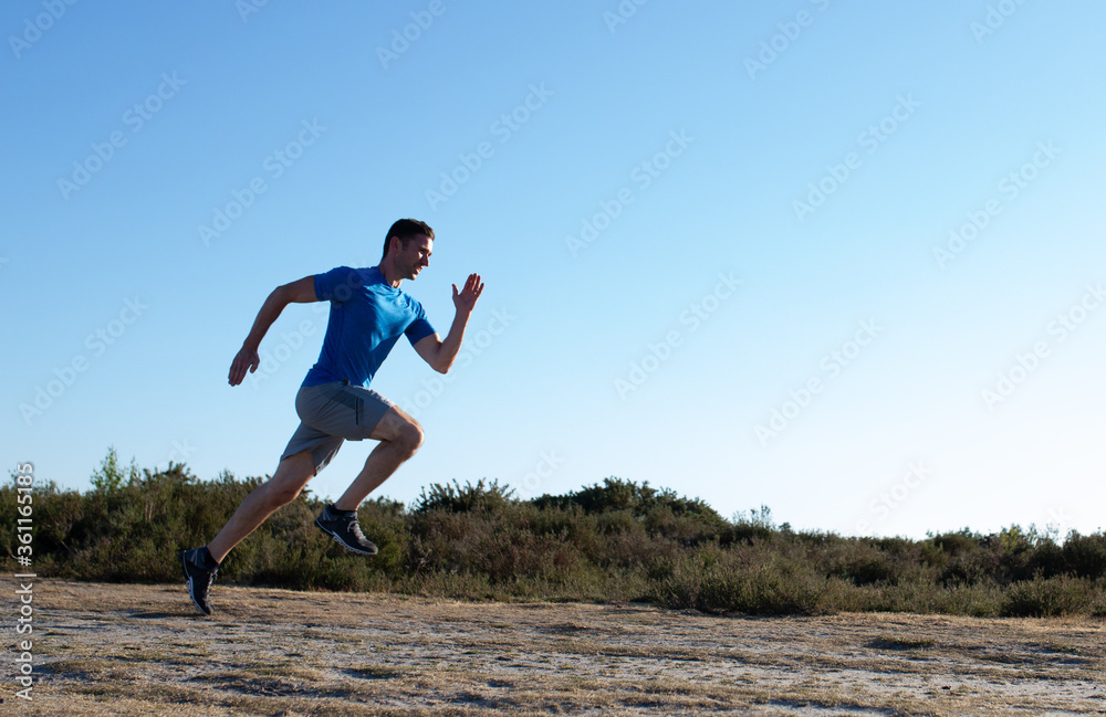 man sprinting in the countryside