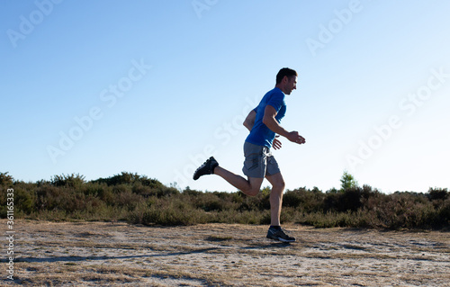man sprinting in the countryside
