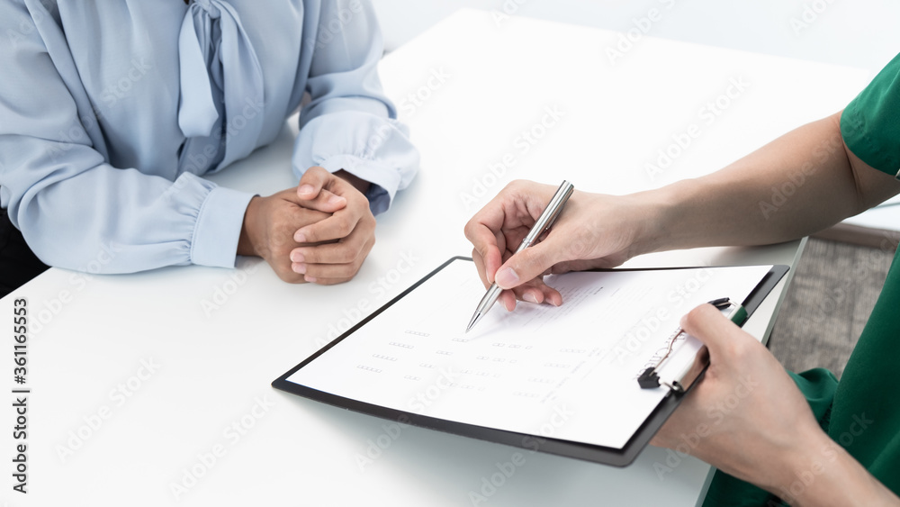 The doctor is consulting about treatment plan with patient in the hospital. The doctor is consulting about treatment plan with patient in the hospital.