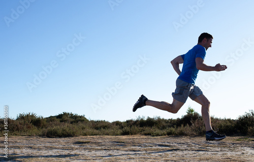 man sprinting in the countryside