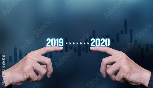 businessmale hands with 2019 to 2020 texts , it means transition between 2019 to 2020