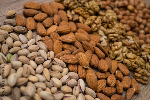 Collected mix nuts: almonds, pistachios, walnuts, hazelnuts. Assorted nuts background