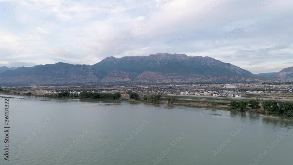 Scenic flight above Utah lake with view of downtown cities with rocky Timpanogos mountain range in background, above circle aerial Scenic flight above Utah lake with view of downtown cities with rocky Timpanogos mountain range in background, above circle aerial