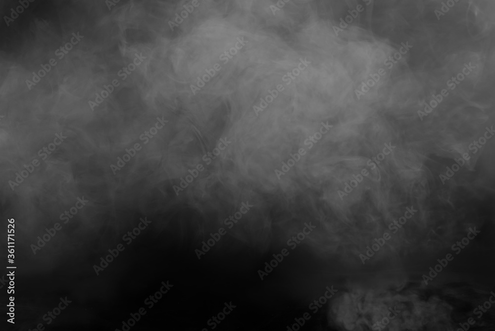 Fototapeta White smoke on a black background. The texture of scattered smoke. Blank for design. Layout for collages.