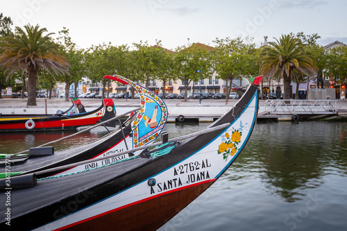 Colorful Moliceiro boat rides in Aveiro are popular with tourists to enjoy views of the charming canals. © Angelino