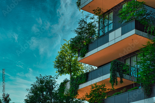 Balconies full with trees, plants on the Vertical Forest (Bosco Verticale) Innovative Green House Skyscraper representing commitment to sustainable economy designed by Boeri